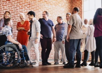 Grupo diverso de personas sonriendo y conversando en un ambiente inclusivo