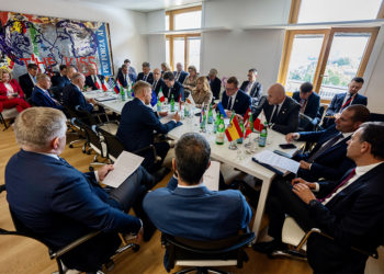 Reunión de líderes europeos en un entorno moderno con banderas