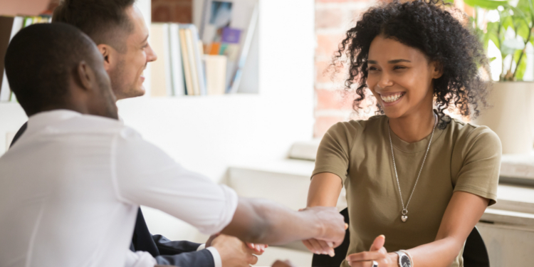 Tres personas en una reunión discutiendo sobre empleo y mercado laboral