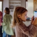 Niña interactuando con un dispositivo de control de temperatura en casa